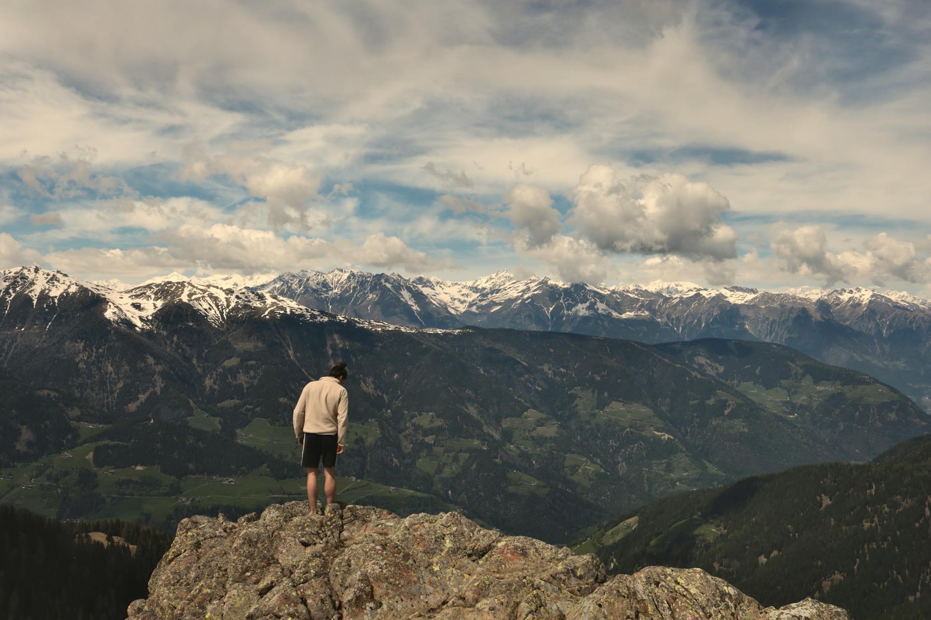 man standing on a rock against mountain landscape