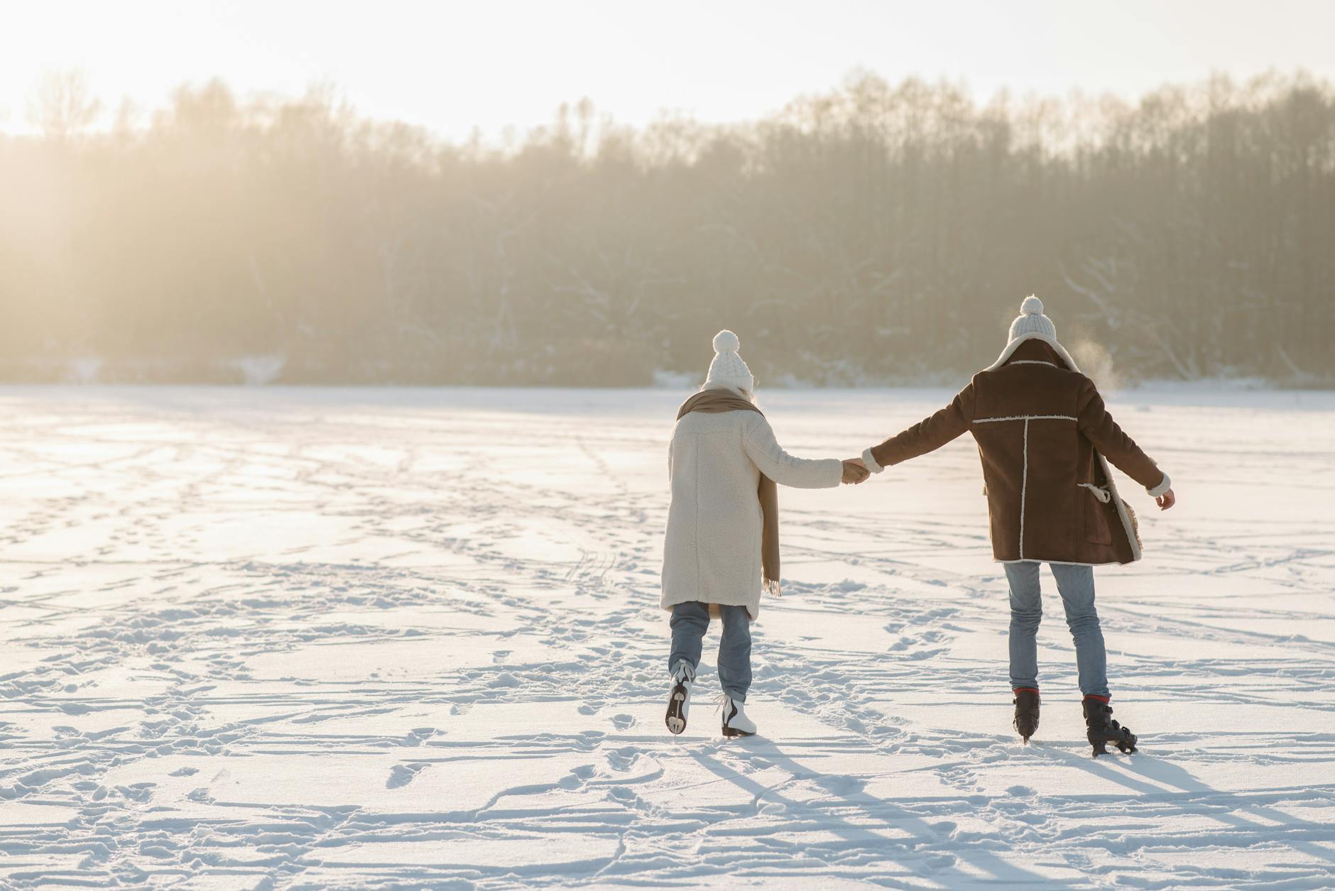 back view of a couple standing on the snow covered ground